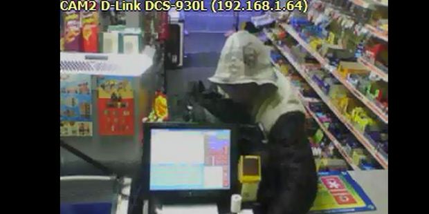 Security footage from the Cameronian Dairy on Cameron Rd shows the moment a hammer-weilding robber rips the store's till from the counter. Image/Supplied