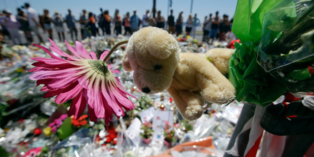 People gather at a makeshift memorial to honour the victims of the attack. Photo / AP