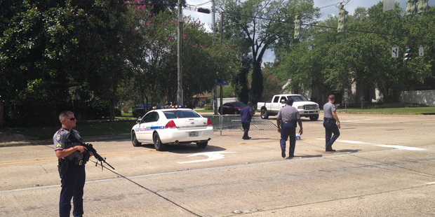 Baton Rouge police officers man a roadblock at Old Hammond Highway and Tara Boulevard after multiple officers were shot. Photo / AP