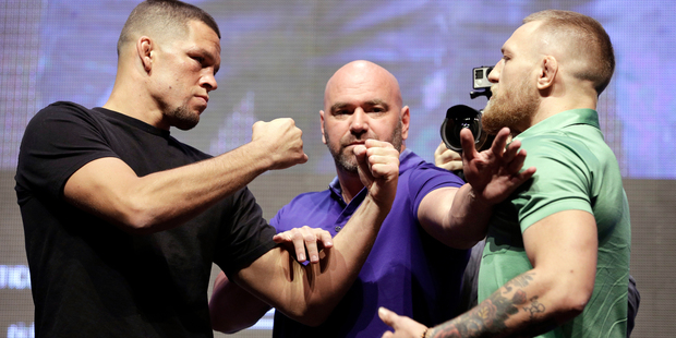 Dana White, centre, stands between Nate Diaz, left, and Conor McGregor. Photo / AP