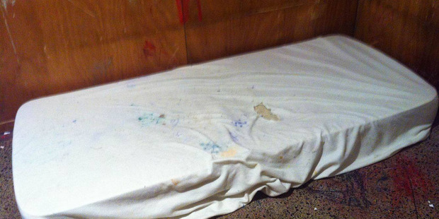 The family has released images of a dirty foam mattress on a floor in a house with boarded windows to highlight his plight. Photo / Supplied