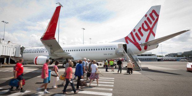 A passenger said the cabin had lost pressure and descended quickly to a low level before returning to Auckland Airport. Photo / Bloomberg