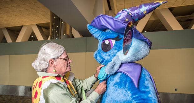 Jasmine Hudson, aka "Granny Smith", helps her son, Judson Hudson, aka "The Great and Powerful Trixie," arrange his costume for a photo. Photo / Washington Post, Andre Chung