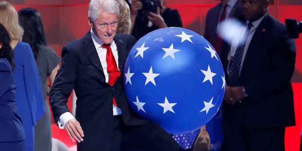 Former President Bill Clinton kicks a balloon at the conclusion of the Democratic National Convention. Photo / AP