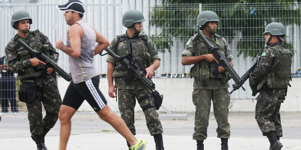 Brazilian soldiers stand on patrol during a security rehearsal of the Rio 2016 Olympic Games opening ceremony outside Maracana stadium. Photo / Getty Images