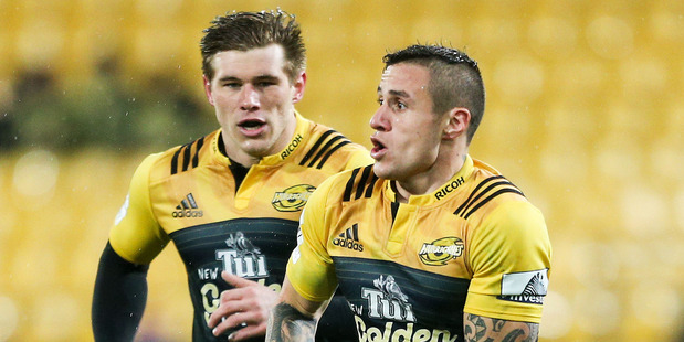TJ Perenara (right) makes a break with Hurricanes teammate Jason Woodward in support. Photo / Getty Images