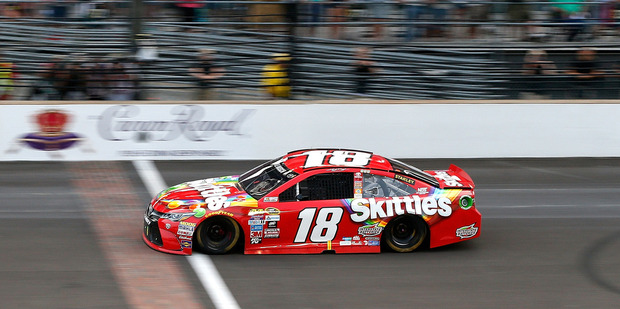 Kyle Busch takes the checkered flag at the Combat Wounded Coalition 400. Photo / Getty Images