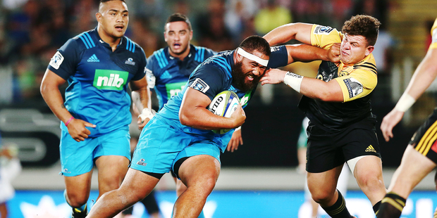 Charlie Faumuina of the Blues fends against Ricky Riccitelli of the Hurricanes. Photo: Anthony Au-Yeung / www.photosport.co.nz