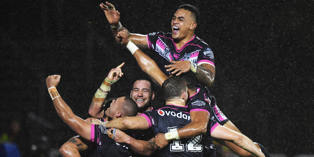 Shaun Johnson celebrates his golden point try with team mates. Photo / Andrew Cornaga