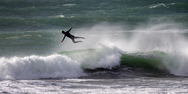 A surfer gets some air at Tay St Beach Mt Maunganui no doubt helped by the powerful offshore winds that buffeted the North Island during Saturday evening and into Sunday. Photo/Alan Gibson