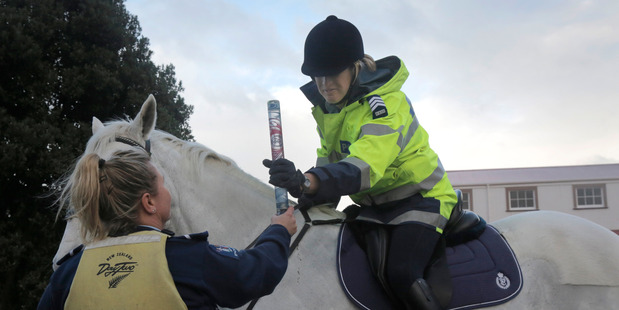 Police relay arrives in Whanganui and Constable Tanya Ross hands the torch to Sgt Rachel Willemsen after carrying it on the Whanganui River. PHOTO/BEVAN CONLEY