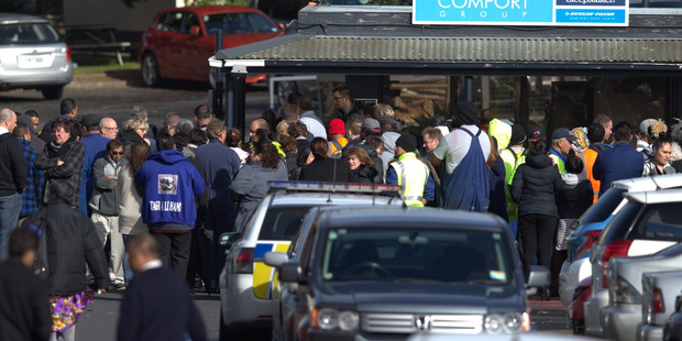 Staff returning to work following an evacuation at the Sleepyhead premises in Otahuhu after a fire. Photo / Jason Oxenham.