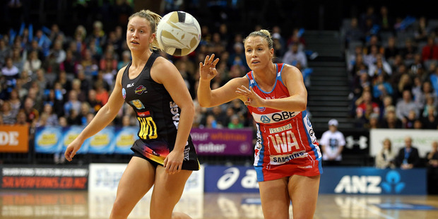 Swifts' Kimberlee Green passes with Magic's Jamie-Lee Price chasing during the ANZ Championship semi-final. Photo / Getty Images