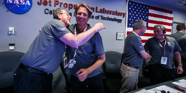 Jim Green, left, celebrates with Scott Bolton in Mission Control at NASA's Jet Propulsion Laboratory. Photo / AP
