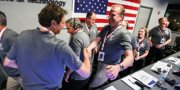 Scott Bolton, left, celebrates in Mission Control at NASA's Jet Propulsion Laboratory as the solar-powered Juno spacecraft goes into orbit around Jupiter. Photo / AP