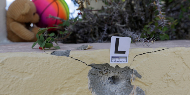 A bullet hole is marked at the scene of a deadly shooting outside the Club Blu nightclub in Fort Myers. Photo / AP