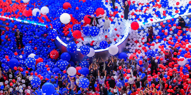 Democratic presidential nominee Hillary Clinton and running mate Senator Tim Kaine stand in a sea of balloons at the conclusion of the Democratic National Convention. Photo/AP