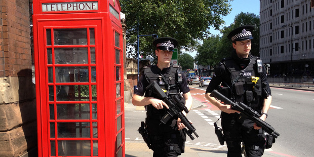 Armed Metropolitan Police patrol the street outside the St Pancras train station. Photo / File