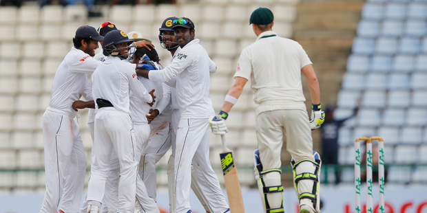 Sri Lankan team members celebrate the dismissal of Australia's Steve Smith. Photo / AP