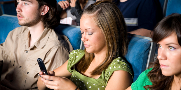 So many people use their phones in cinemas these days that ushers have often given up trying to stop them. Photo / iStock