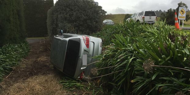 A car is on its side after rolling on State Highway 2 earlier today. Photo/Allison Hess