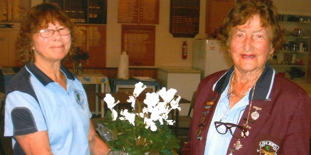 FLOWER POWER: Faye Irwin Erceg (right) is awarded with life membership and presented with a cyclamen plant by Kaitaia Church Road Bowling Club vice president Anne Inglis. PICTURE/SUPPLIED
