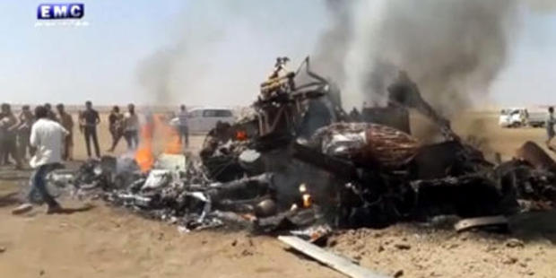 This image made from video provided by Thiqa news agency, purports to show people gathered around the burning wreckage of a Russian helicopter. Photo / AP