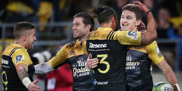 Beauden Barrett (R) of the Hurricanes celebrates with teammates after scoring a try against the Chiefs. Photo / Getty