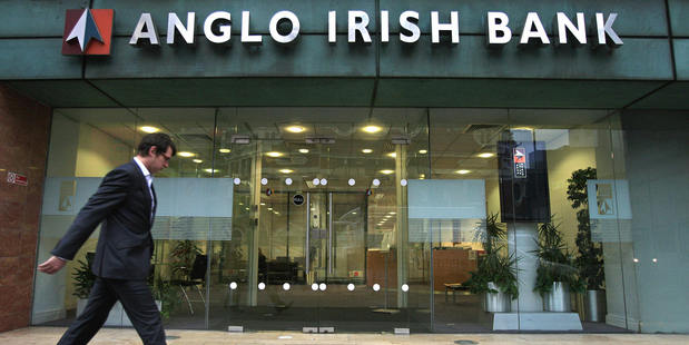 People walk past a branch of an Anglo Irish Bank in Belfast, Northern Ireland. Photo / Getty Images