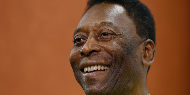 Brazilian soccer legend Pele smiles during a media opportunity at a restaurant in London. Photo / AP