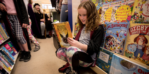 Tabitha Sellar, 8, from Herne Bay gets her hands on the latest Harry Potter book from Dorothy Butler Children's Bookshop in Ponsonby. Photo / Dean Purcell