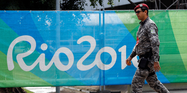 A soldier walks past a security fence outside the boxing arena as preparations continue for the 2016 Summer Olympics in Rio de Janeiro. Photo / AP