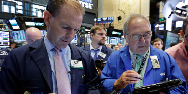 Traders Michael Smyth, left, and Eugene Mauro, right, work on the floor of the New York Stock Exchange. Photo / AP