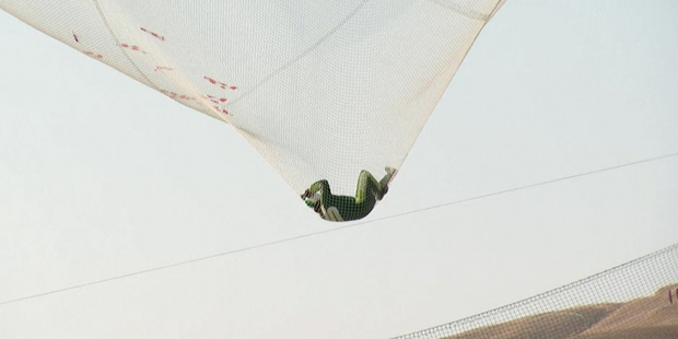This image made from a video provided by Mondelez International shows Luke Aikins in a net after successfully skydiving without a parachute in Simi Valley, Calif. Photo / AP.