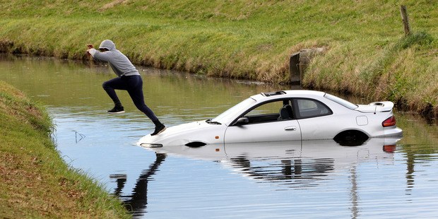 The teen takes a leap of faith across the creek. Photo: Paul Taylor