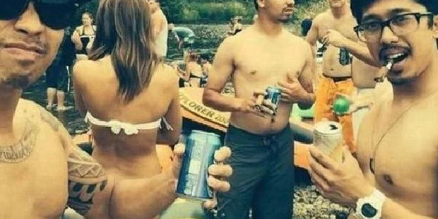This man's arm is just in the right place and bent at such an angle that the woman looks like she has lost her bikini bottoms.
