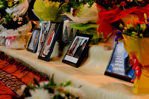 Before the service began several women adorned the stage with tapa cloth, woven mats, flowers and the photographs of the five Tongan men. Photo/Ruth Keber