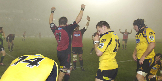 The Crusaders celebrate their win after the fogbound Super 14 rugby final against the Hurricanes at Jade Stadium.