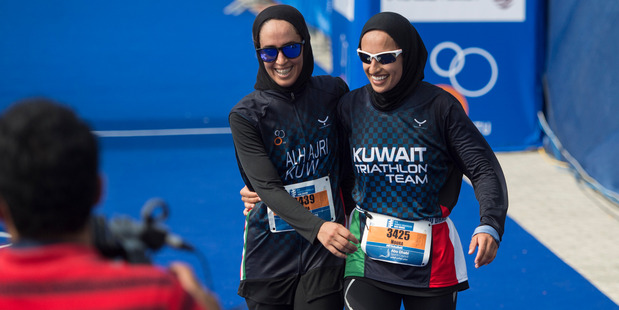 Nada Aljeraiwi, left, and Noura Al Hajeri share a laugh after completing in the ITU World Triathlon Abu Dhabi, United Arab Emirates earlier this year. Photo / Nikki Kahn