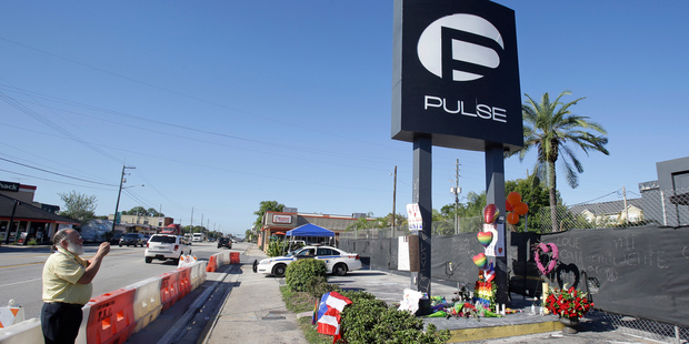 A passerby takes a photo of the Pulse nightclub. Photo / AP