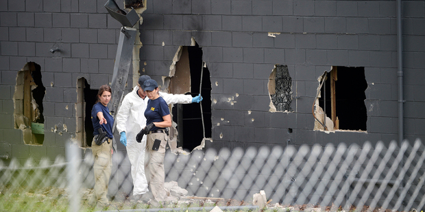 Police officials investigate the back of the Pulse nightclub. Photo / AP