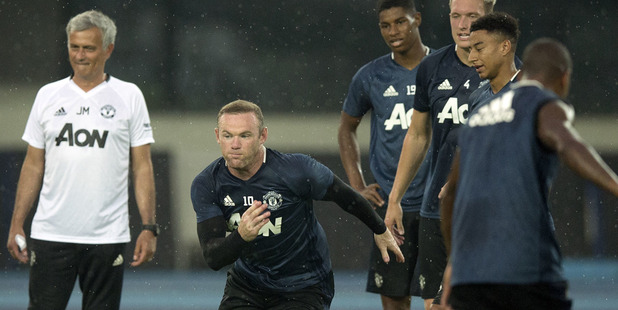 Manchester United's Wayne Rooney sprints during the team's training session at the Olympic Sports Center Stadium in Beijing. Photo / AP