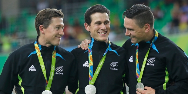 New Zealand silver medallists, from left, Ethan Mitchell, Sam Webster and Eddie Dawkins on the podium at the Rio Olympic Velodrome. Picture / AP
