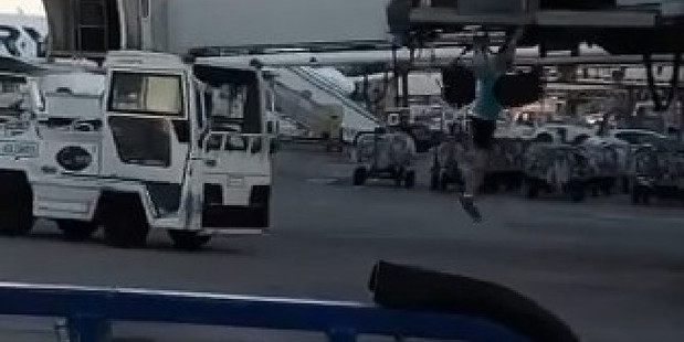 The man jumped about two metres from the bridge with his carry-on in tow. Photo / Facebook