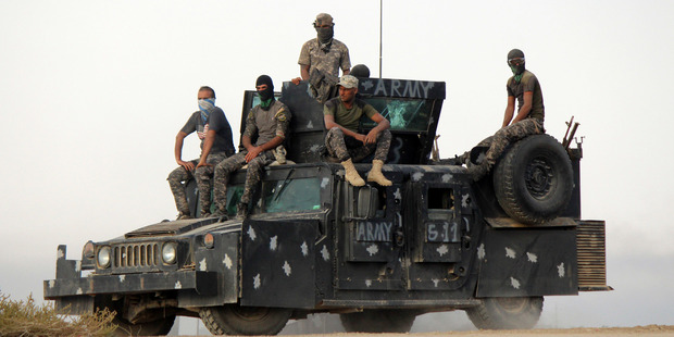 Iraqi security forces backed by allied Shia Popular Mobilisation forces and Sunni tribal fighters prepare to attack Isis positions at Khalidiya Island in Anbar province, Iraq. Photo / AP