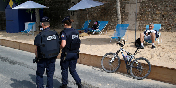 French police officers patrol at Paris Plage (Paris Beach), an artificial beach set up on the right bank of the Seine. Photo / AP