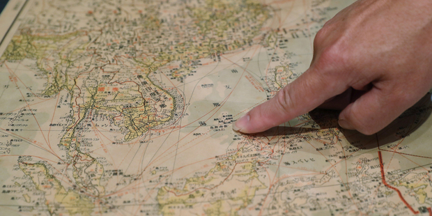 Marcopolo Tam, a member of a pro-China business group in Hong Kong, points to what is now known as the Spratly Islands in the South China Sea. Photo / AP