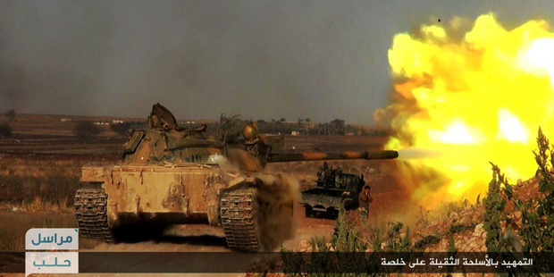 A tank being used by Syria's al-Qaeda-linked Nusra Front fires at Syrian troops in southern Aleppo. Photo / AP