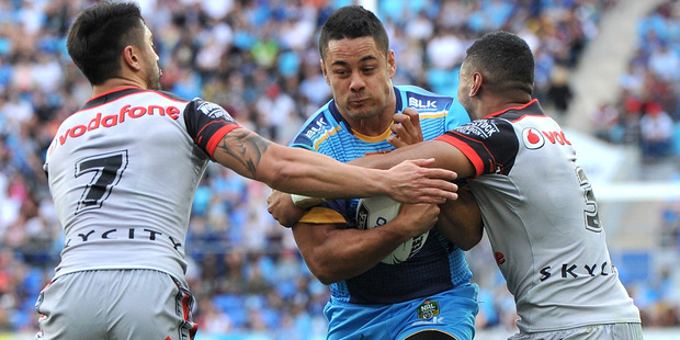 Jarryd Hayne of the Titans takes on the defence in his first run and first match for the club. Photo / Getty