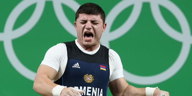 Andranik Karapetyan of Armenia was injured during the Men's 77kg Group A weightlifting contest. Photo / Getty Images
